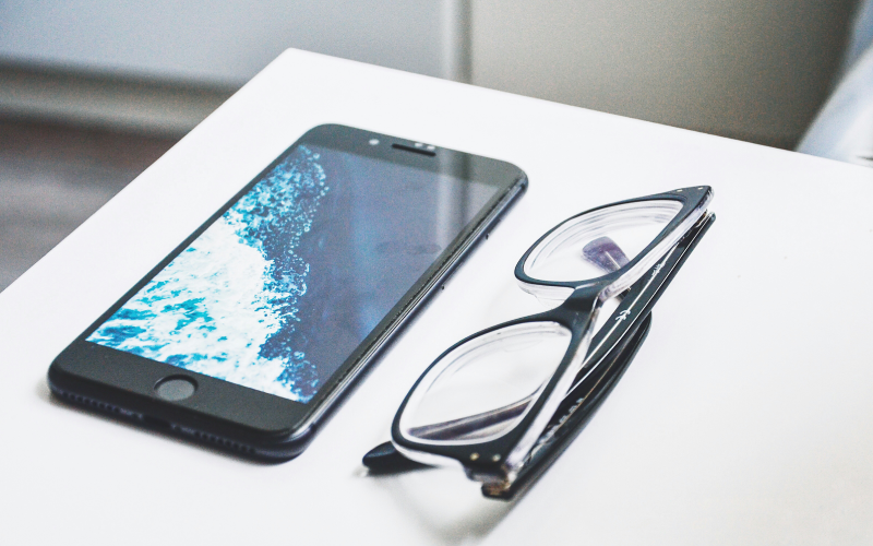 Mobile and glasses on table