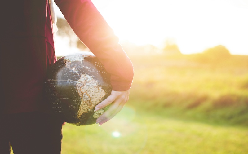 Person holding a globe